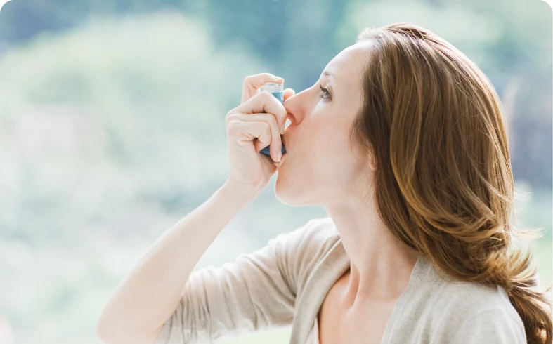 Female with inhaler against blurred background