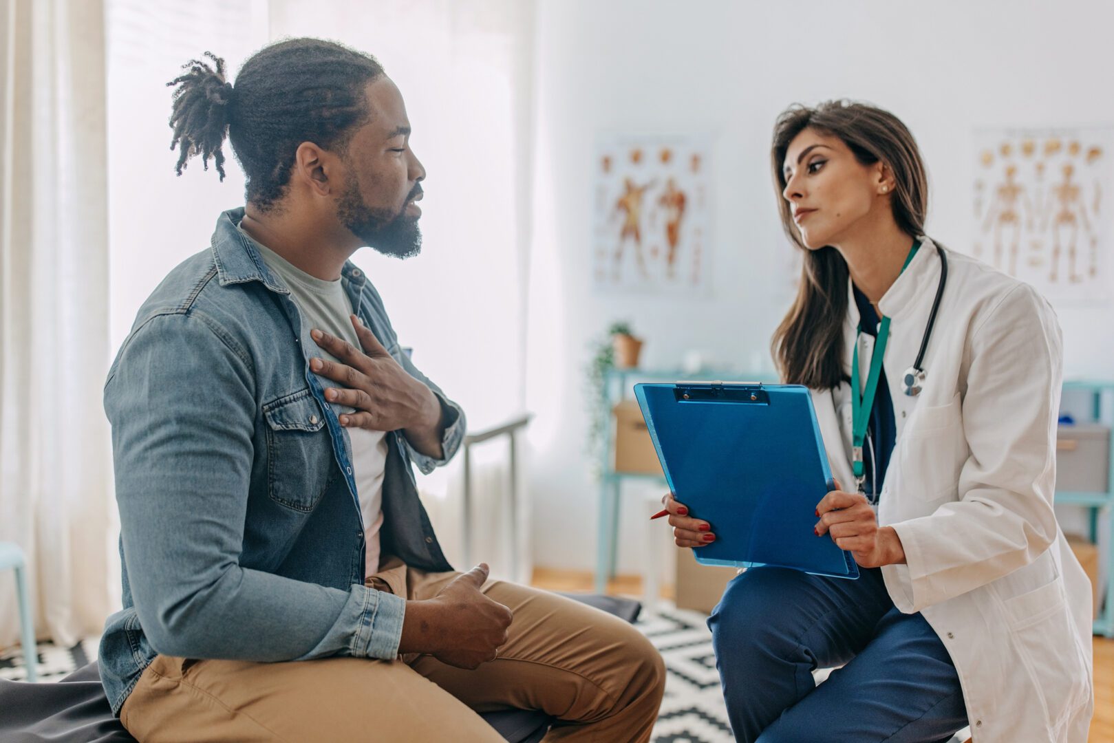 Beautiful brunette doctor talking to African American patient