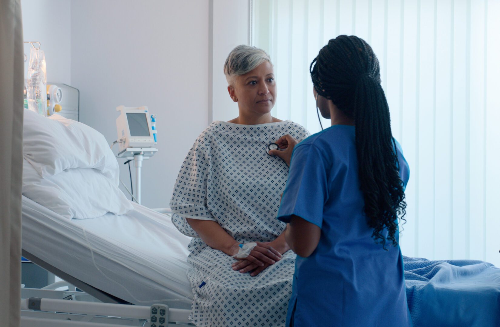 Senior, woman and nurse with stethoscope for cardiology with healthcare, patient heartbeat and consultation. Rear view, doctor and elderly person with health instrument, medical support and listening