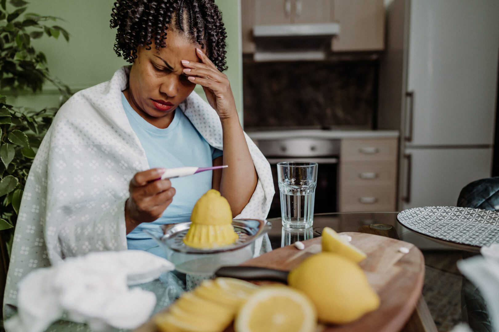 Mid adult woman experiencing flu symptoms