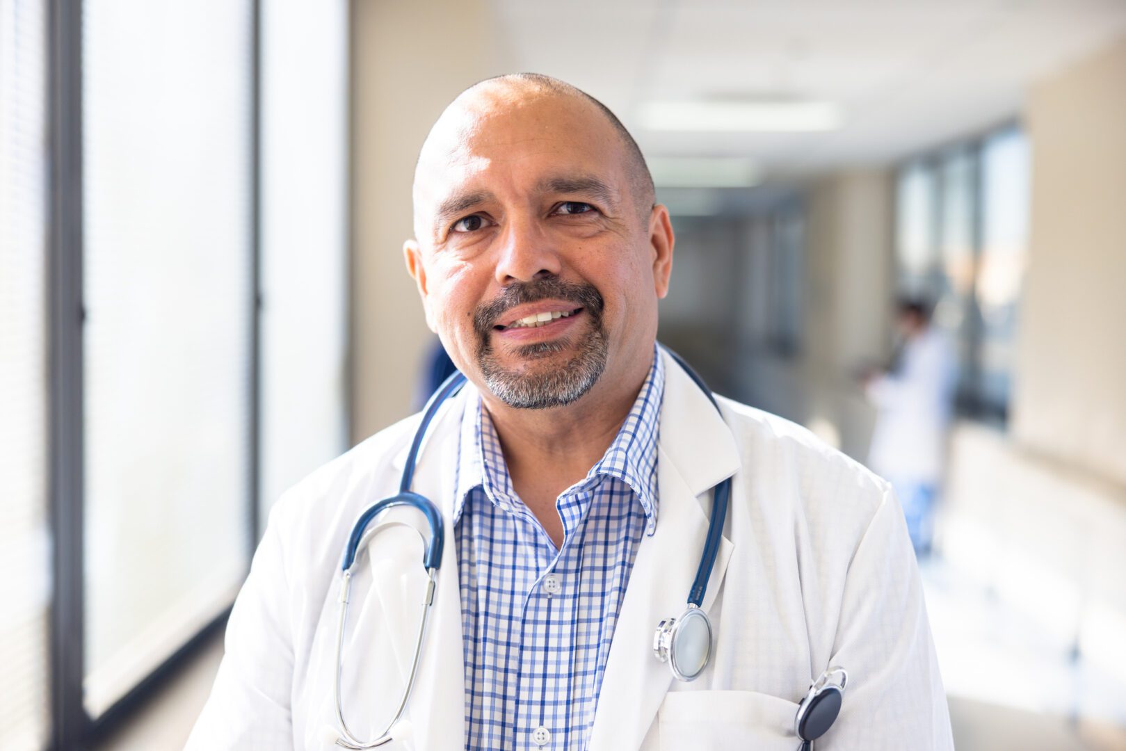 Portrait of a mature hispanic male nurse in the hospital hallway
