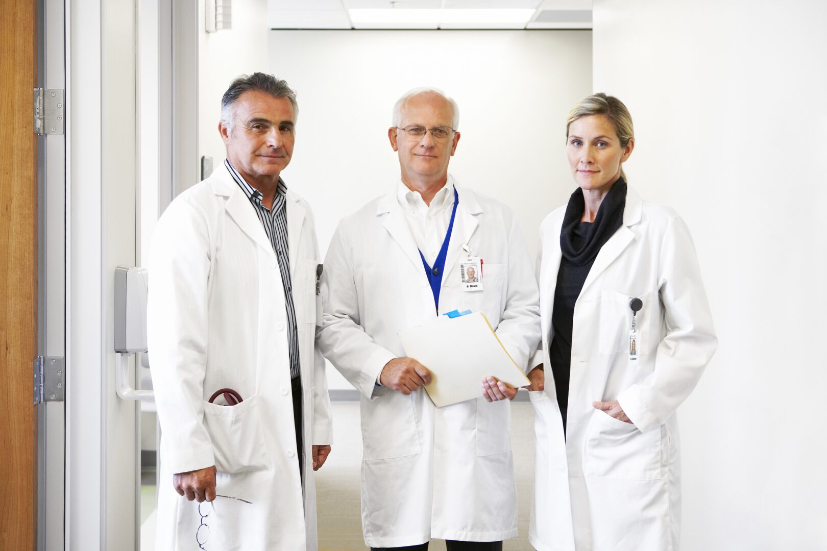 portrait of three doctors in hospital corridor