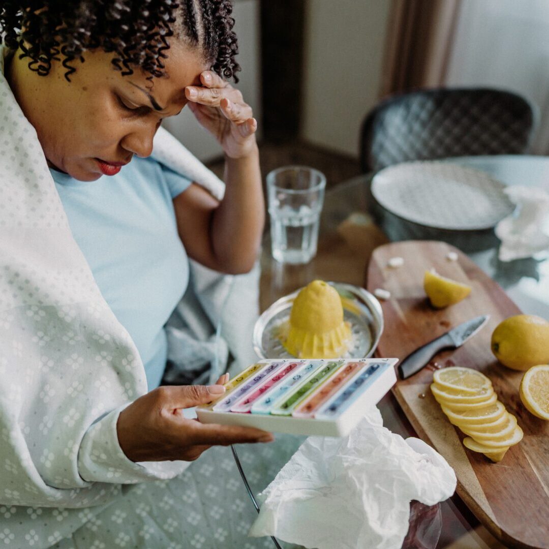 Mid adult woman experiencing flu symptoms